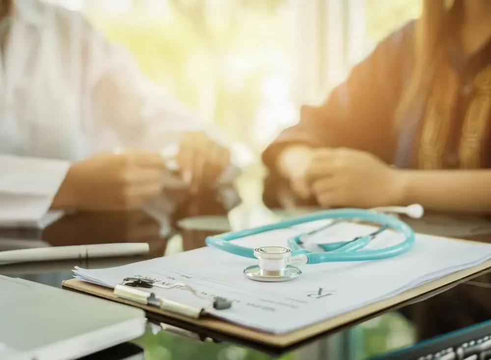 patient-talking-to-doctor-in-the-background-chart-in-the-foreground
