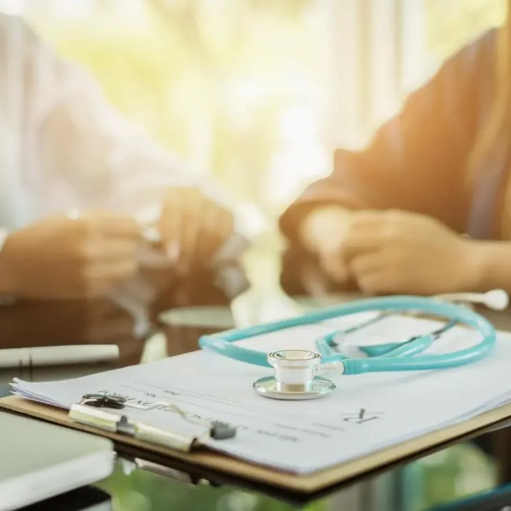 patient-talking-to-doctor-in-the-background-chart-in-the-foreground